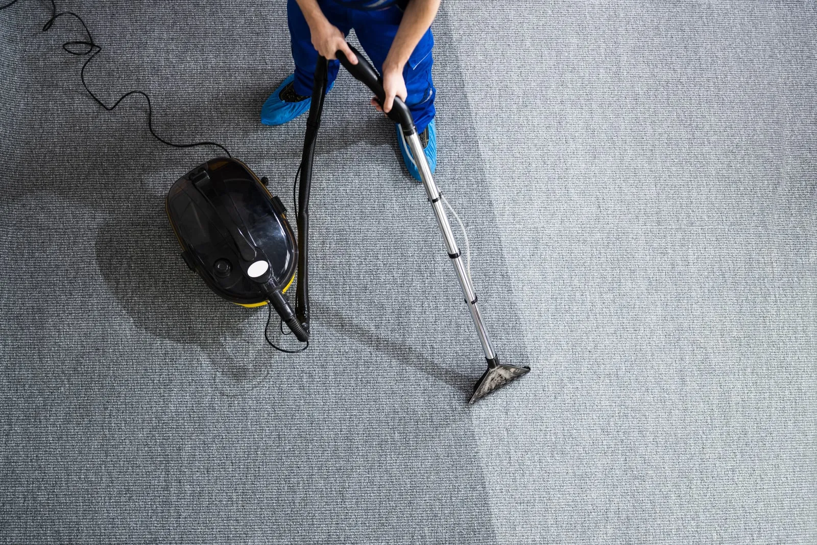 Commercial carpet being cleaned in an office hallway