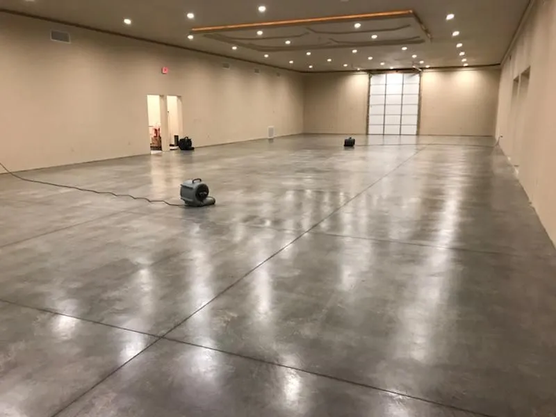Construction worker performing post-construction cleaning on a commercial buildout in Greensboro