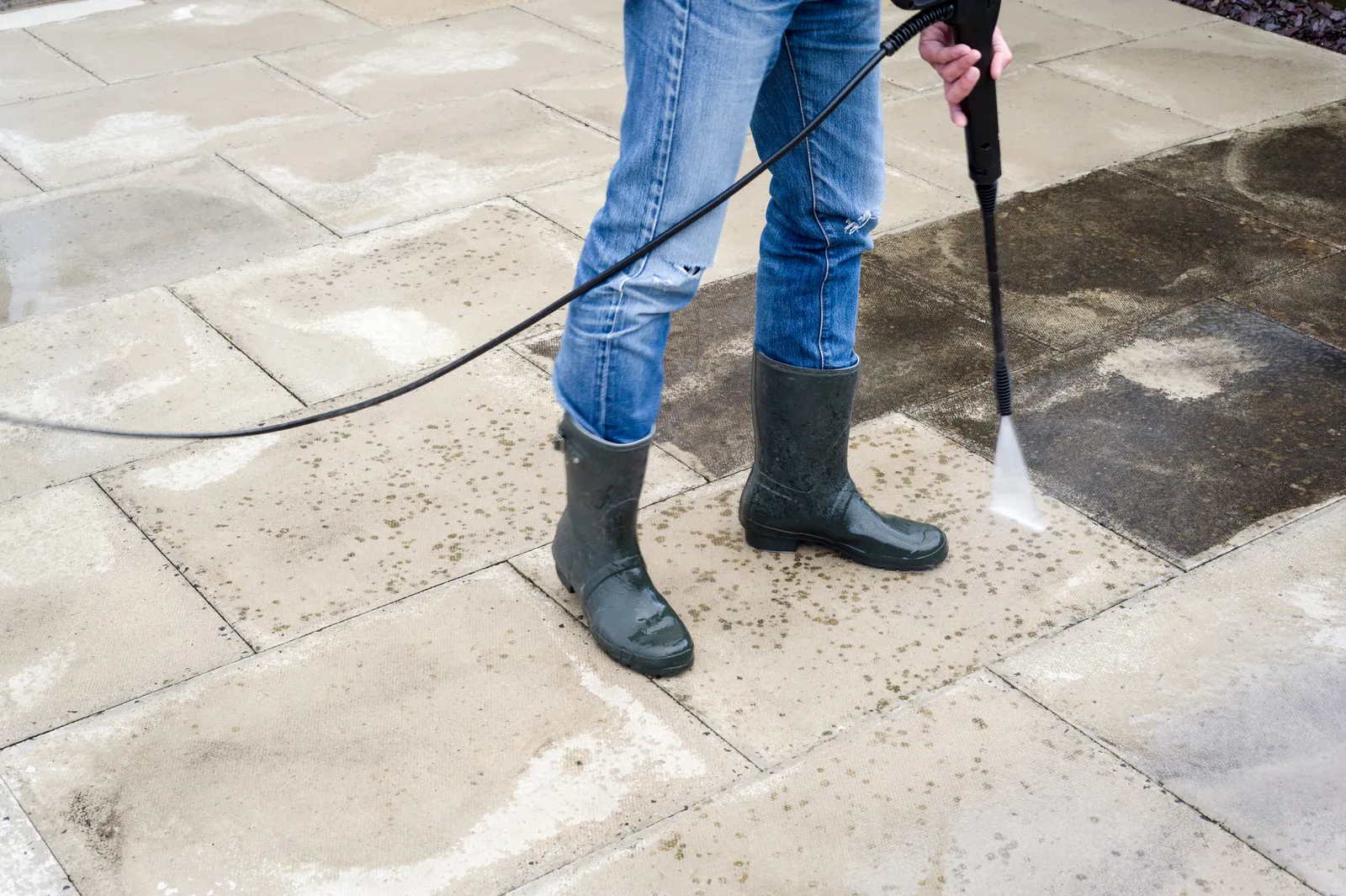 Pressure washing concrete surface outside a commercial building