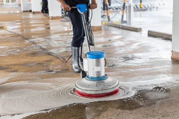 Noble technician operating a commercial floor scrubber on tile flooring in Greensboro NC